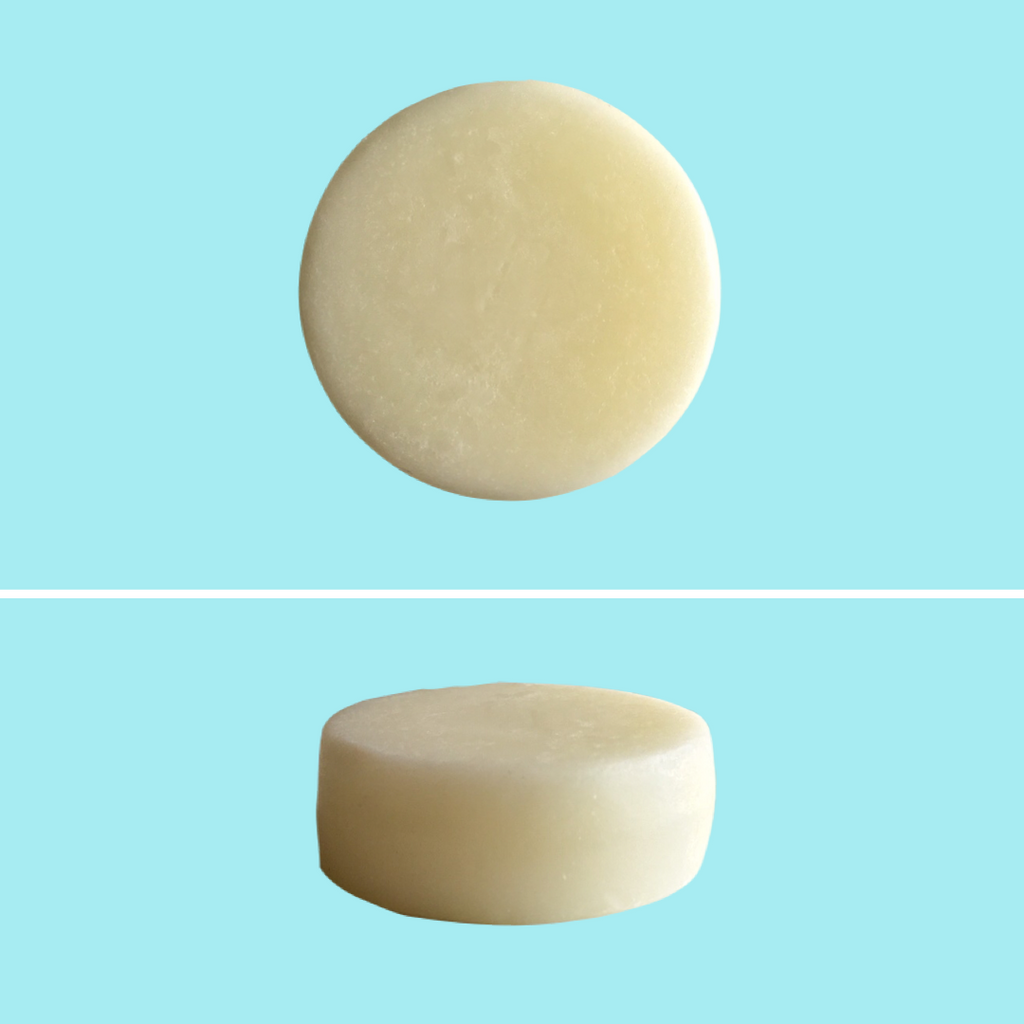 Top and side view of Green Ablutions Purifying Peppermint Conditioner Bar on blue background. Sustainable Zero-waste Plastic-free haircare.