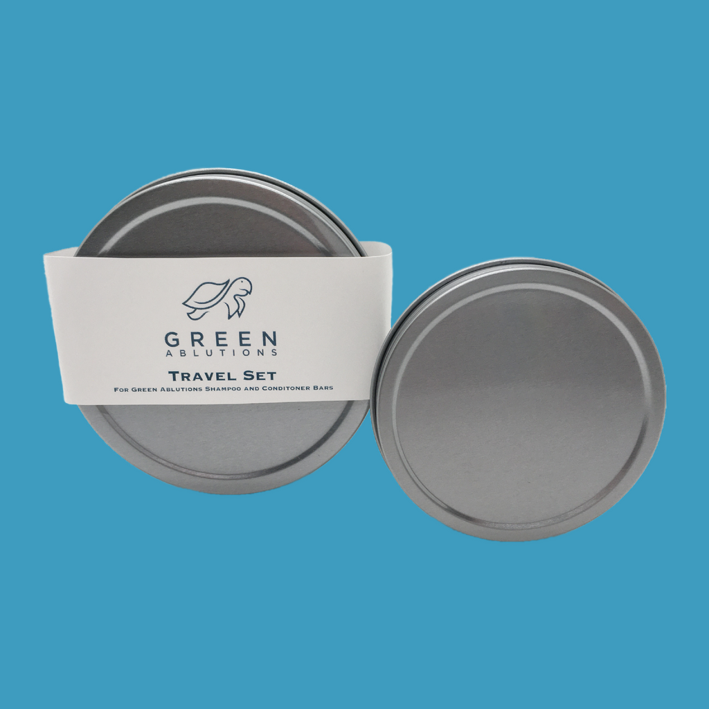 Two tins on blue background sized to hold Green Ablutions zero waste sustainable plastic free shampoo and conditioner for travel, camping or home use by the whole family. 