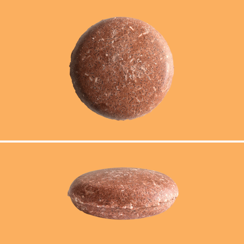 Top and side view of Green Ablutions Moroccan Argan Oil Shampoo Bar on orange background. Sustainable Zero-waste Plastic-free haircare.
